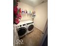 Functional laundry room with tile flooring and modern, front-loading washer and dryer at 1711 Jaques Dr, Lebanon, IN 46052