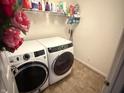 Bright laundry room with newer washer and dryer and shelving at 1711 Jaques Dr, Lebanon, IN 46052