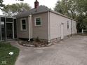 Tan house with a screened-in porch at 1741 N Riley Ave, Indianapolis, IN 46218
