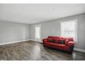 Cozy living room with hardwood floors, bright walls, and a comfortable red sofa at 1915 Albany St, Beech Grove, IN 46107