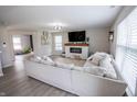 Bright living room featuring a cozy fireplace, large sectional, and neutral decor at 1981 Turning Leaf Dr, Franklin, IN 46131