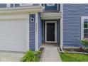 Close-up of home's entrance featuring the front door, house number, and siding detail at 2485 Bristol Dr, Franklin, IN 46131