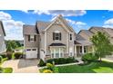 Charming two-story home with manicured lawn and beautiful landscaping near a pond at 2789 W High Grove Cir, Zionsville, IN 46077