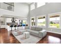 Bright open-concept living room with hardwood floors, gray sofas, and a view of the water at 2789 W High Grove Cir, Zionsville, IN 46077
