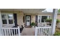 Inviting front porch with a porch swing and white railings at 3039 28Th St, Columbus, IN 47203