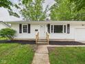 Traditional-style home with black shutters and a neatly landscaped front yard leading to a welcoming front door at 308 Mohawk St, Anderson, IN 46012