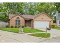 Lovely single-story home with well-maintained landscaping, brick facade, and an attached two-car garage at 3304 Fox Orchard Cir, Indianapolis, IN 46214