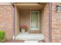Charming entryway with a well-lit porch, potted flowers, and a welcoming 'hello' doormat at 3304 Fox Orchard Cir, Indianapolis, IN 46214