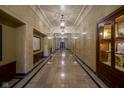 Long hallway with marble floors, paneled walls, and classic lighting fixtures at 350 N Meridian St # 505, Indianapolis, IN 46204