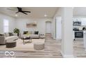Bright living room featuring modern lighting, stylish decor, and an open layout, seamlessly connects to the kitchen at 3558 N Gladstone Ave, Indianapolis, IN 46218