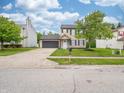 Inviting two-story home featuring attached garage, driveway and a well-manicured front lawn at 3734 Lacebark Dr, Indianapolis, IN 46235