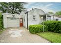 Traditional home boasts attached garage, colorful door, and beautiful landscaping at 400 E 34Th St, Anderson, IN 46013