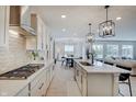 Open concept kitchen with granite countertops, stainless steel appliances, and view to dining and living area at 4163 Ironclad Dr, Bargersville, IN 46106