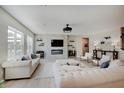 Bright living room with modern fireplace, large windows, stylish sofas and ample seating for entertaining guests at 4163 Ironclad Dr, Bargersville, IN 46106