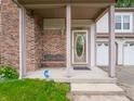 Covered front porch with brick columns and bench seating by front door at 4382 Castlebay Way, Indianapolis, IN 46254