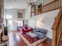 Spacious living room with vaulted ceilings, hardwood floors, and large windows at 4382 Castlebay Way, Indianapolis, IN 46254