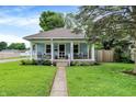 Quaint home featuring a welcoming porch and lush green lawn, perfect for outdoor enjoyment at 4641 Crittenden Ave, Indianapolis, IN 46205