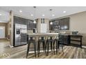 Contemporary kitchen showcasing stainless steel appliances, stylish cabinetry, and bar seating for casual dining at 4736 Blue Marlin Way, Indianapolis, IN 46239