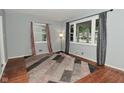 Bright living room with ample natural light, hardwood floors, and a stylish area rug at 4751 N Longworth Ave, Indianapolis, IN 46226