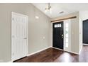 Bright foyer featuring wood floors, a dark front door with glass, and a white interior door at 572 Quail Ridge Dr, Westfield, IN 46074