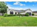 Charming ranch home featuring a well-manicured lawn, a gray garage door, and manicured shrubs at 572 Quail Ridge Dr, Westfield, IN 46074