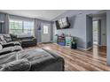 Spacious living area with wood floors, fireplace, TV, large windows, and comfortable seating at 5811 Simmul Cir, Indianapolis, IN 46221