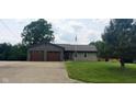 Inviting single-story home featuring a brick accented two-car garage and well-manicured lawn at 600 Old Moore Rd, Martinsville, IN 46151