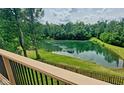 Picturesque pond view from a deck, surrounded by lush greenery and mature trees, offering a serene escape at 600 Old Moore Rd, Martinsville, IN 46151