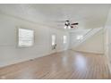 Inviting living room with laminate wood floors, white walls, and natural light at 616 S Fuller Dr, Indianapolis, IN 46241