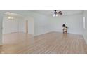 Bright living room featuring laminate wood flooring and modern ceiling fan at 616 S Fuller Dr, Indianapolis, IN 46241