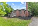 Charming red brick home featuring a well-manicured lawn and a classic chimney at 6477 N Park Ave, Indianapolis, IN 46220