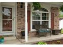 Cozy front porch with a wicker bench, perfect for relaxing and enjoying the outdoors at 6927 Rose Tree Ct, Indianapolis, IN 46237
