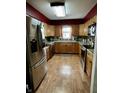 Well-lit kitchen with stainless steel appliances and light wood cabinets at 719 Henry St, Lebanon, IN 46052