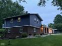 Beautiful exterior view featuring a brick and siding home with a cozy covered porch and landscaped yard at 75 Byram Blvd, Martinsville, IN 46151