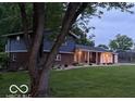 Charming split-level home featuring a brick facade, blue siding, covered porch and large garage at 75 Byram Blvd, Martinsville, IN 46151
