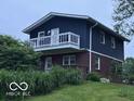 This split-level home boasts a spacious deck and large windows bringing lots of light to the interior at 75 Byram Blvd, Martinsville, IN 46151