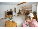 Spacious living room with neutral carpet, ceiling fan and comfortable furnishings at 7632 Sea Crest N Way, Noblesville, IN 46062