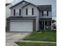 Charming two-story home featuring vinyl siding, red shutters, and an attached two-car garage at 8056 Maple Stream Blvd, Indianapolis, IN 46217