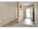 Inviting entryway featuring a neutral color palette, wood-look flooring, and a carpeted living space at 8148 Gathering Cir, Indianapolis, IN 46259