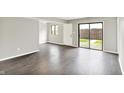 Bright living room with luxury vinyl floors, white trim, and sliding glass door to the backyard at 8545 La Corrida Ct, Indianapolis, IN 46227