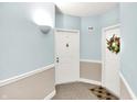 Bright hallway featuring neutral-toned walls and carpet, leading to unit doors at 8720 Yardley Ct # 108, Indianapolis, IN 46268