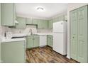 Charming kitchen with updated cabinets, modern appliances, and wood-look flooring at 8720 Yardley Ct # 108, Indianapolis, IN 46268