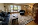 Cozy living room with hardwood floors, comfortable seating, and natural light from large windows at 902 N Bauman St, Indianapolis, IN 46214