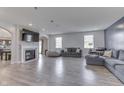 Bright living room featuring a fireplace, large windows, and sleek wood flooring at 928 Ridge Rock Ln, Bargersville, IN 46106