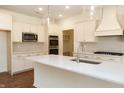 Bright, modern kitchen featuring white cabinetry, stainless steel appliances, and a large island at 0 Whitetail Ridge Lot 3, Mooresville, IN 46158