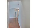 Hallway with wood floors leading into the condo, showcasing a warm and inviting transition space at 1074 Timber Creek Dr # 8, Carmel, IN 46032
