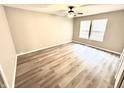 Bedroom featuring hardwood floors, a ceiling fan, and a large window providing natural light at 10922 Snowdrop Way, Indianapolis, IN 46235