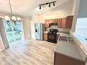 Open kitchen and dining area with stainless steel appliances and access to deck through sliding glass doors at 10922 Snowdrop Way, Indianapolis, IN 46235