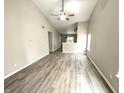 Bright living room with vaulted ceilings, ceiling fan, and modern light-colored wood flooring at 10922 Snowdrop Way, Indianapolis, IN 46235