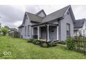 Inviting two-story home with a well-manicured lawn and cozy front porch at 1201 Villa Ave, Indianapolis, IN 46203